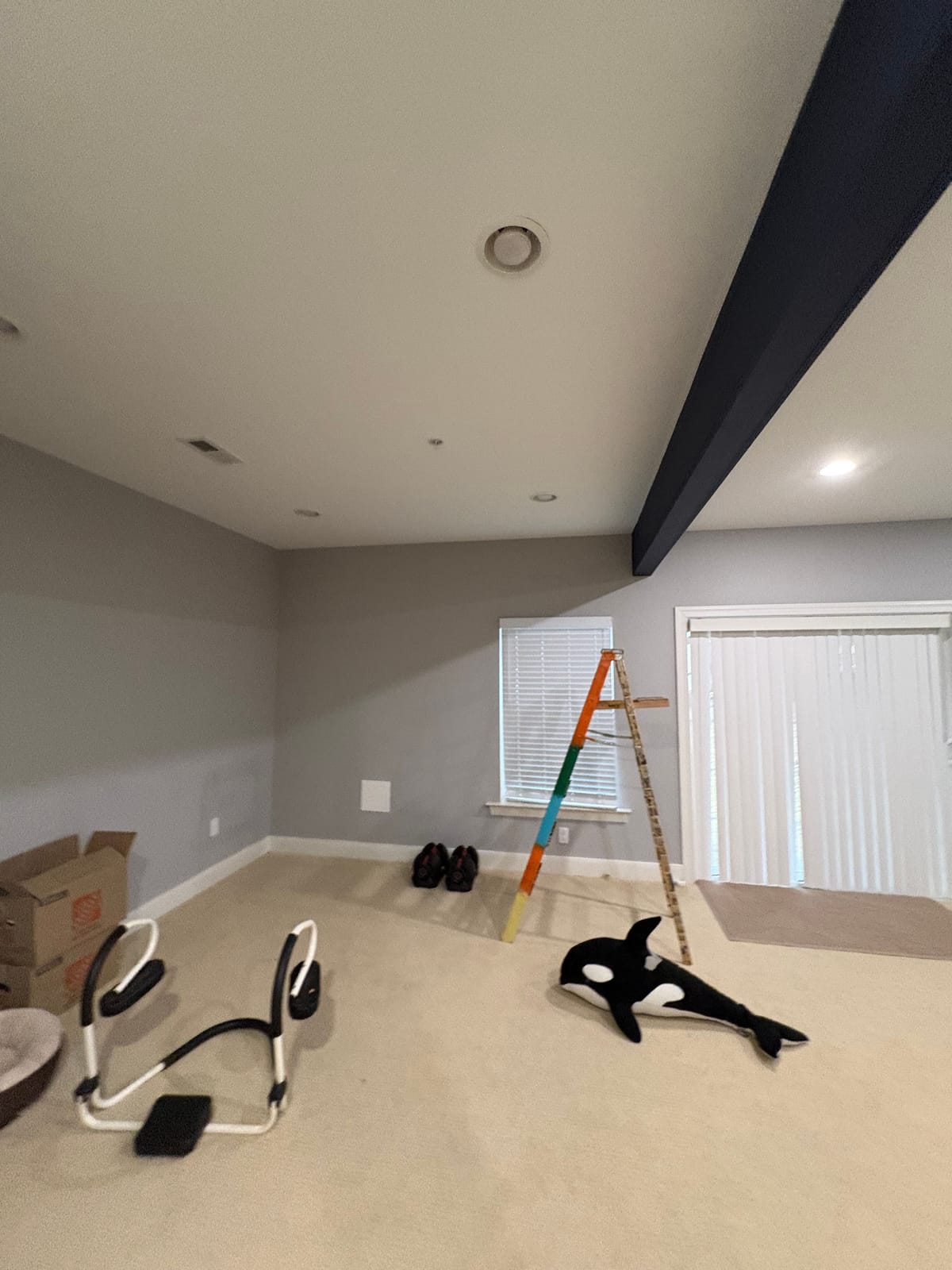 The basement as found, with exercise equipment along a bare wall.