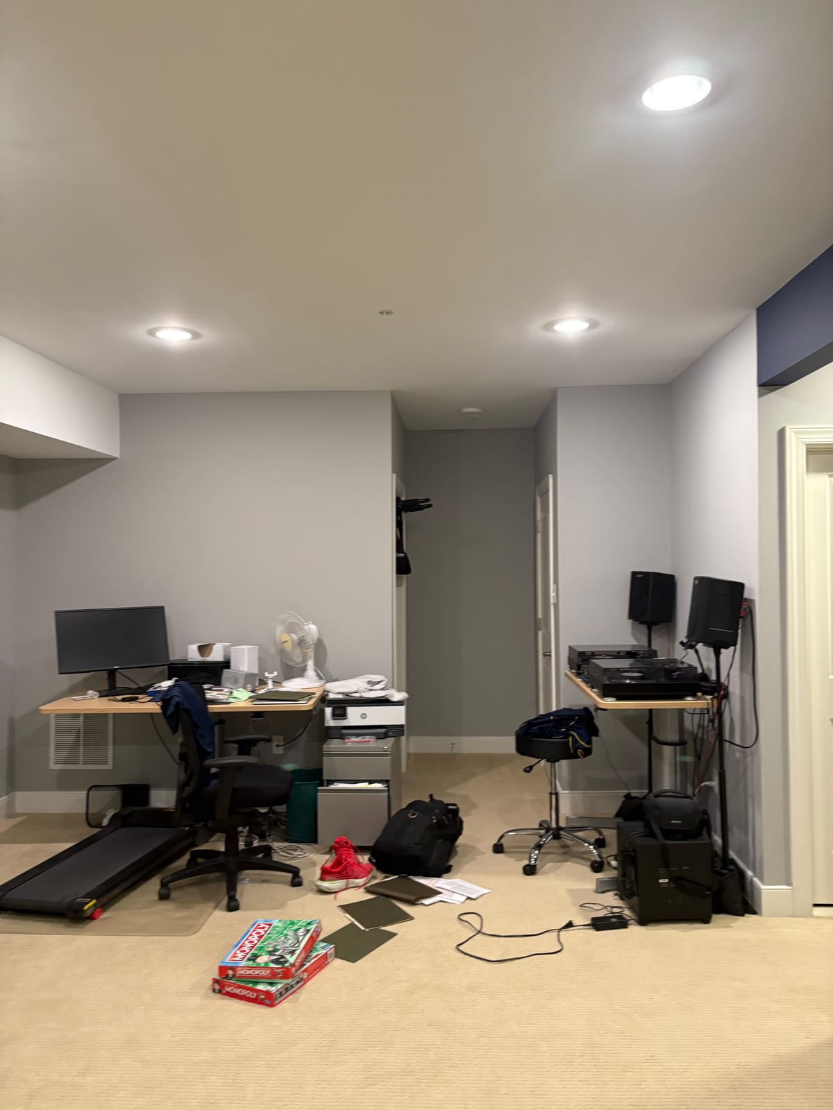 Another corner of the basement as found, with a desk, cables and stacked boxes.
